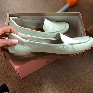 Mint green colored women loafers.